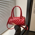 Chic red polka dot cylinder handbag with top handles and adjustable crossbody strap - Red