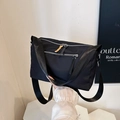 Black nylon crossbody bag with dual front pockets and orange zipper pulls for gym or travel - Black