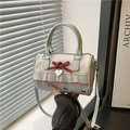 Polka dot Boston bag in mint blue with red ribbon and heart pendant detail - Blue