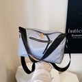 Waterproof light gray nylon crossbody bag with black wide straps and orange zipper accents - Gray