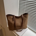 Brown matte tote bag with leather handles placed on a windowsill for a casual look - Brown