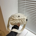 Cream canvas crossbody bag with pleated front pocket and circular metal M logo detail - White