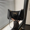 Elegant black patent leather shoulder bag with gold metal bow and polished finish - Black