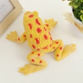 Squeeze frog stress relief toy in yellow with red spots on a white textured surface - Yellow Frog / Yellow