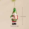 Painted glass Christmas gnome ornament playing accordion with green hat and glitter details - Accordion Gnome Santa