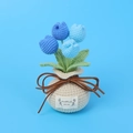Detail of handmade crochet blue tulip potted plant with a woven gift bag base - Gradient Blue