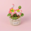 Detail of hand-crocheted lotus bonsai with pink flowers and a Handmade With Love label - White Pot Style