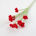 Detail of handcrafted crochet baby breath flower with red petals and white pearl bead center - Red