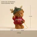 Christmas resin bear ornament with gold antlers and stars on cream background - Bear With Magic Wand