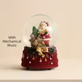 Christmas Santa musical snow globe with red knit texture base and golden bow detail - Christmas Snow Globe A