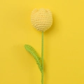Handmade crochet yellow tulip flower gift with detailed knitted texture on yellow background - True Yellow