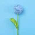 Detail of a handmade blue crochet tulip flower with fine knitted textures and green stem - Blue