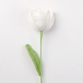 Detailed knit texture of a handmade white tulip flower with green stem and leaf - Open Tulip / White