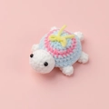 Close-up of handmade crochet turtle with colorful shell and yellow bow tie detail - Bowknot (Turtle Doll)