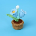 Detailed crochet view of blue lily of the valley and white flower in a yarn pot - Double Head Lily of the Valley (Small Yarn Pot) / Blue