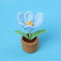 Macro shot of handmade crochet light blue tulip in a brown pot with green leaves - Blue - Flowering Tulip Potted Plant (Small Yarn Pot)