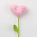 Detailed view of hand-crocheted pink heart flower with green stem and leaf textures - Pink Heart Bouquet (Green Leaves)