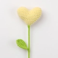 Detail of handcrafted crochet heart flower with intricate knitted texture and green leaf - Yellow Heart Bouquet (Green Leaves)