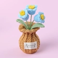 Detailed close-up of handmade crochet blue forget-me-not flowers in a knitted brown pot - 3 Heads Lily of the Valley Brown Vase - Blue