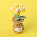 Detailed macro view of handmade crochet sunflower potted plant with soft yarn texture - Segment Dyed Yellow-Puff Flower Brown Vase