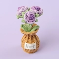 Macro detail of hand-knitted purple roses in a yarn pot with Handmade With Love label - Gradient Purple-Rose Brown Vase