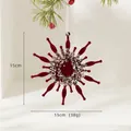 Velvet burgundy snowflake Christmas ornament with gold sequins on green pine tree branch - Snowflake A Style (WH252469)