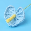 Detailed view of handmade crochet anthurium flower with intricate knitted blue heart petals - Blue