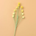 Close-up of handmade crochet snowberry bouquet with soft yellow knit buds and green stems - Berry Branch / Gradient Yellow