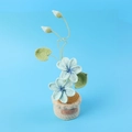 Detailed crochet blue tung flower plant with leaves and a handmade leather tag - Blue