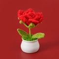 Macro detail of hand-knitted red crochet rose in a white ceramic pot for home decor - Red