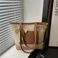 Handwoven straw tote bag with large lace bow and brown leather handles for beach travel - Beige