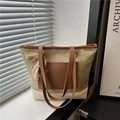 Handwoven straw tote bag with brown leather trim and elegant lace bow detail - Khaki