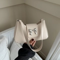 Cream white shoulder bag with silver bow buckle, minimalist faux leather handbag design - White