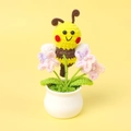Handmade crochet potted plant featuring a cute bee and pink flowers with pearl details - Bee Gathering Nectar - Purple Forget-Me-Not