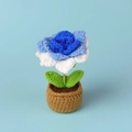 Macro detail of handmade crochet flower in blue and white gradient with green leaves - Gradient Blue