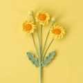 Handcrafted crochet daisy bouquet with yellow petals on a matching vibrant background - Daisy Bouquet / Yellow