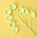 Macro detail of handmade crochet green leaf ornament with soft cotton yarn texture - Yellow