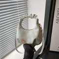 Pale green crescent shoulder bag with ruffle handle and golden metal hardware detail - Green