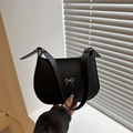 Minimalist black crescent shoulder bag with silver metal bow and matte leather finish - Black