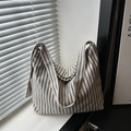 Minimalist striped canvas tote bag with black vertical stripes on a soft beige background - Black