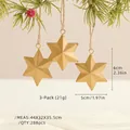 Three-pack of vintage matte gold star Christmas ornaments hanging on a pine tree - Small Stars (Set of 3) / Matte Gold