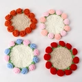 Macro view of handmade crochet coasters featuring 3D wool roses in multiple colors - Orange