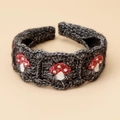 Macro detail of knit headband with red mushroom patterns on dark grey woolen texture - Mushroom Headband - Black