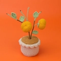 Handmade crochet potted orange fruit plant with green leaves and a cream knit base - Persimmon Potted