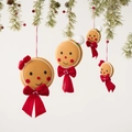 Set of four plush gingerbread man ornaments with red bows hanging on a Christmas tree - Gingerbread Man Ornaments Set of 4