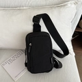 Minimalist black nylon crossbody bag with adjustable strap in home setting - Black