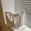White faux leather tote bag with crocodile texture and golden rivet detailing - White