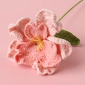 Detailed macro view of handmade crochet lisianthus with pink petals and green leaves - Gradient Pink
