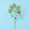 Detailed knit texture of handmade crochet bouquet with blue flowers and green leaves - Blue