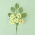 Close-up of handmade crochet flowers with five yellow petals and green leaves on a stem - Green